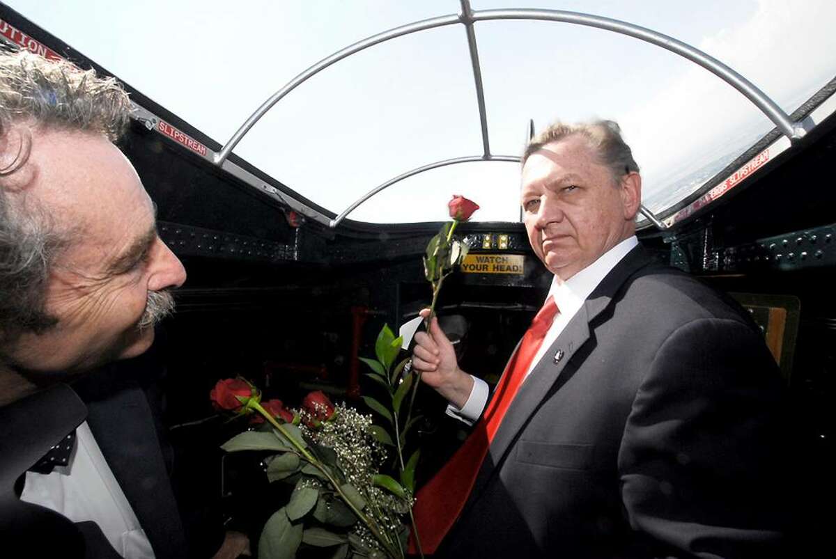 Michael J. Sulick, right, director of the National Clandestine Service of the Central Intelligence Agency, accompanied by Rabbi Harvey Abramowitz, prepares to release a dozen roses over the Statue of Liberty in New York, on Monday, from a World War II Boeing B-17 Flying Fortress to pay tribute to seven CIA employees who were killed in a bomb blast in Afghanistan set off by a double agent. (AP Photo/American Airpower Museum, Nancy Epstein)