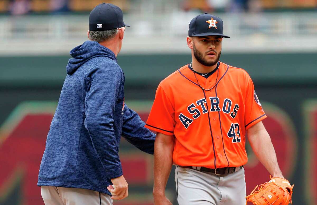 Houston Astros pitcher Lance McCullers Jr., right, gets a pat on the back from manager Al Hinch as he is pulled in the fourth inning of a baseball game after giving up a two-run home run to Minnesota Twins' Max Kepler Wednesday, April 11, 2018, in Minneapolis. (AP Photo/Jim Mone)