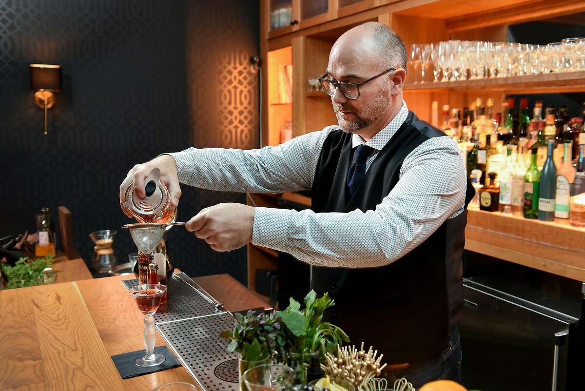General manager Ron Boyd mixes up an "In a Nutshell" cocktail in the Linden Room at Nightbird restaurant in San Francisco, Calif., Friday March 30, 2018.