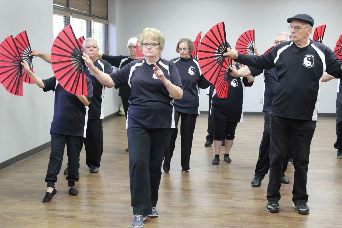 Members of The Woodlands Tai Chi Practice Group move through synchronized steps during tai chi practice on Tuesday, April 10, at the South Regional Community Center. The group invites the public to practice on Saturday, April 28, at Creekside Park Village Green for World Tai Chi Day.