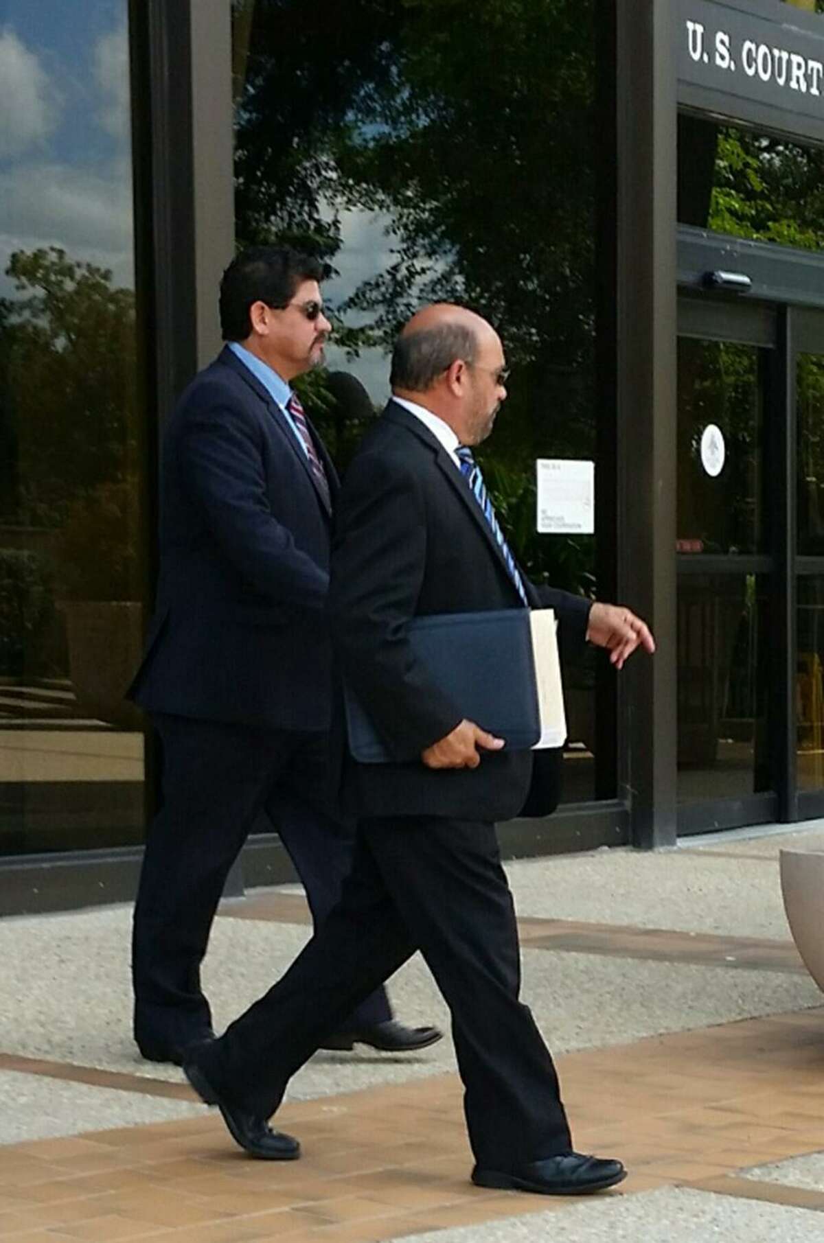 Samuel Mullen, (left) walks out of federal court tin San Antonio with his lawyer, David R. Gorena (right,) in 2016.