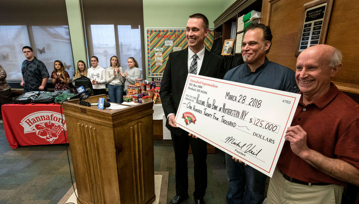 Local chef Rick Orlando (center) joins Brad Fabre, a community relations specialist at Hannaford Supermarkets (left) and Mark Quant, executive director of the Regional Food Bank of Northeastern New York, at a check presentation March 28, 2018 at Heatly School in Green Island, N.Y. (Skip Dickstein/Times Union)