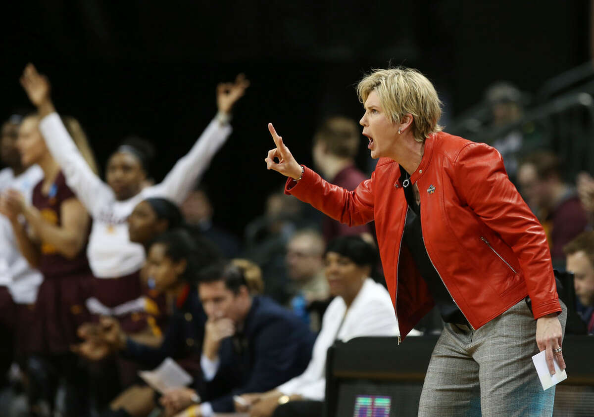 Minnesota coach Marlene Stollings, right, calls to her team during the first half of a second-round game against Oregon in the NCAA women's college basketball tournament in Eugene, Ore., Sunday, March 18, 2018. (AP Photo/Chris Pietsch)