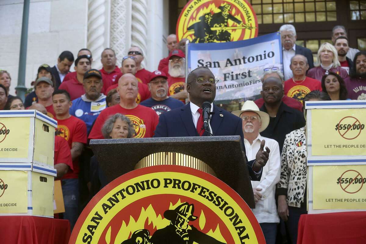 Chris Steele, (center, at lectern) president of the San Antonio firefighters union, speaks Wednesday April 11, 2018 on the steps of City Hall about a petition campaign to call for a city charter amendment election in November. Steele and his supporters delivered thousands of signatures to the city clerk after he and his supporters voiced their opinions outside of city hall.