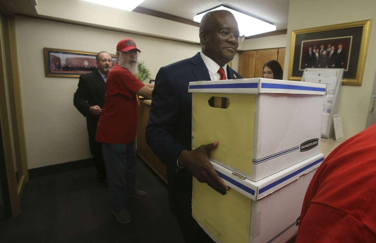 In April, Chris Steele, (foreground) president of the San Antonio firefighters union, delivered boxes filled with signed petitions for three proposed City Charter amendments to City Hall.