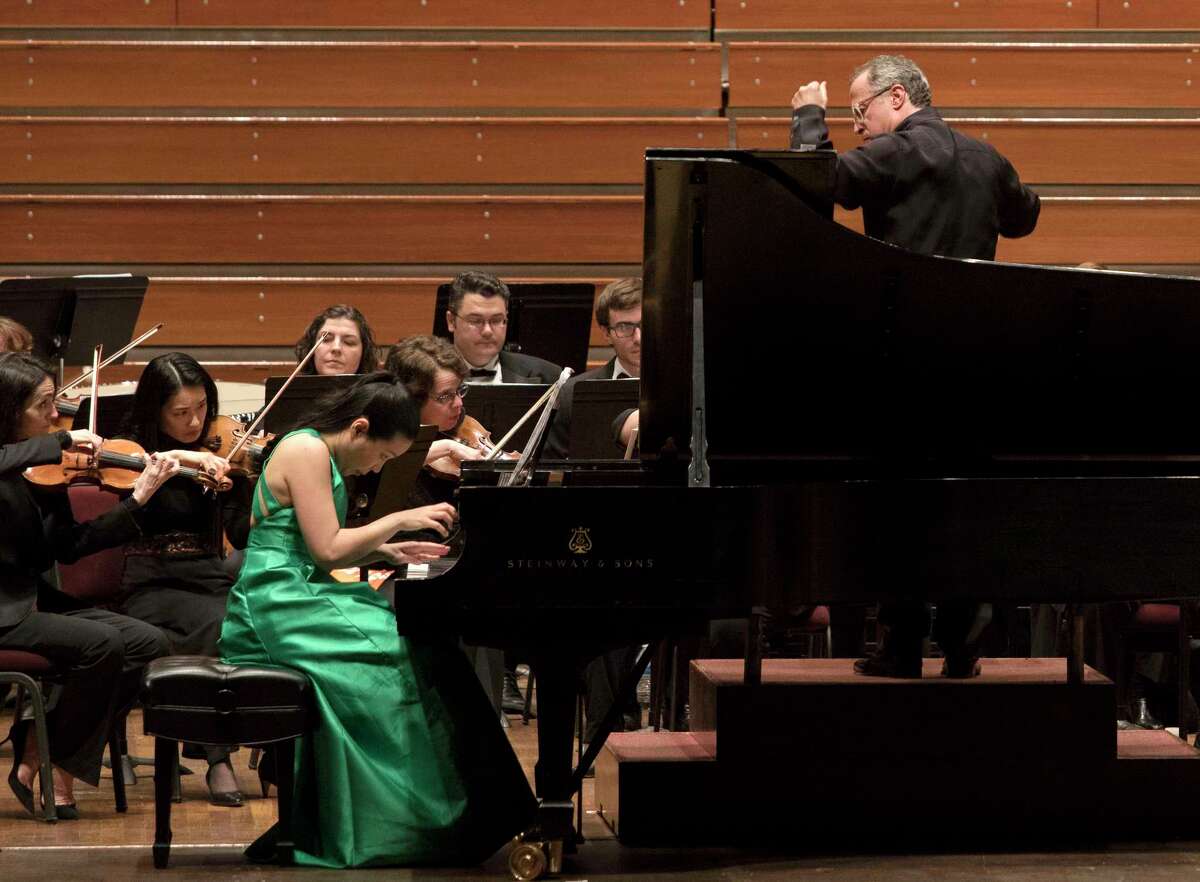 Pianist Joyce Yang, left, is led by Albany Symphony conductor David Alan Miller, right, as the symphony performed Joan TowerOs OStill/Rapids for Piano and Orchestra,O during the SHIFT Festival of American Orchestras, at the Kennedy Center on Wednesday, April 11, 2018, in Washington D.C. (Eliza Mineaux/Special to the Times Union)