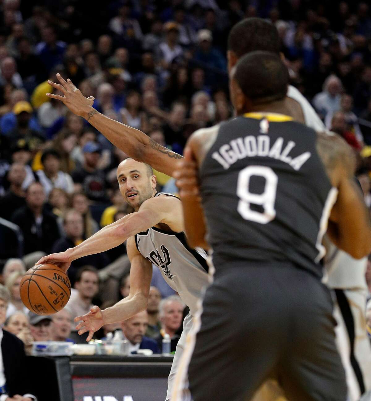 Manu Ginobli (20) passes to LaMarcus Aldridge (12) in the first half as the Golden State Warriors played the San Antonio Spurs at Oracle Arena in Oakland, Calif., on Saturday, February 10, 2018.