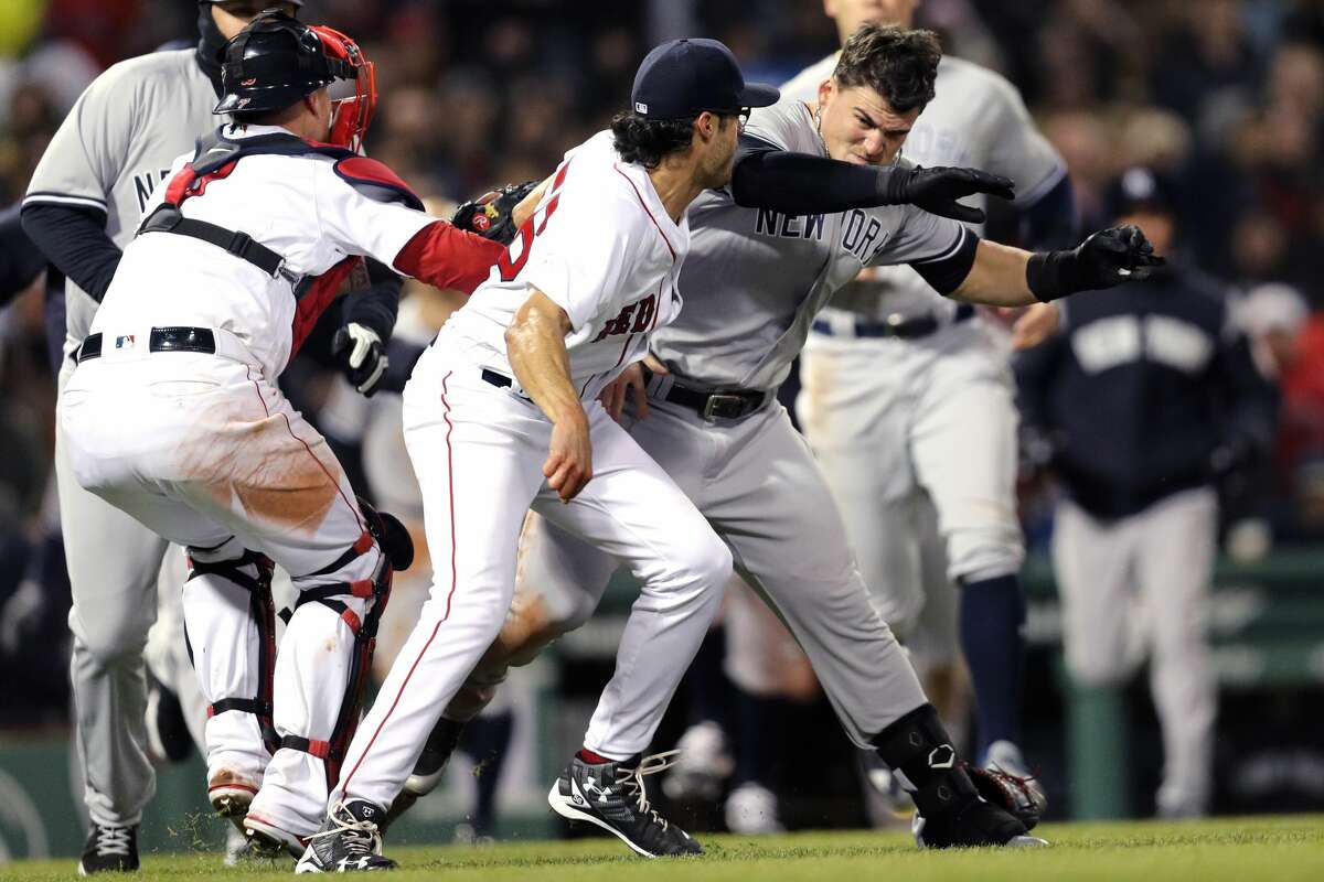 BOSTON, MA - APRIL 11: Tyler Austin #26 of the New York Yankees fights Joe Kelly #56 of the Boston Red Sox after being struck by a pitch Kelly threw during the seventh inning at Fenway Park on April 11, 2018 in Boston, Massachusetts. (Photo by Maddie Meyer/Getty Images)