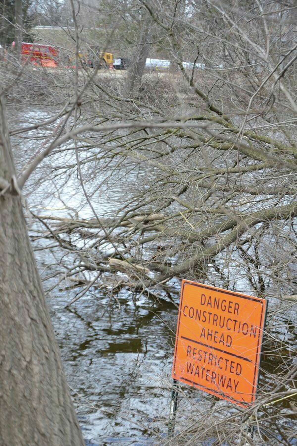 This sign on the Tittabawassee River, just upstream of the Tridge, alerts boaters and anglers to the fact that the river has been narrowed in the area of the Robertson Bridge over M-20 while the bridge is being rebuilt (as seen in the background). (Steve Griffin/Hearst Michigan)