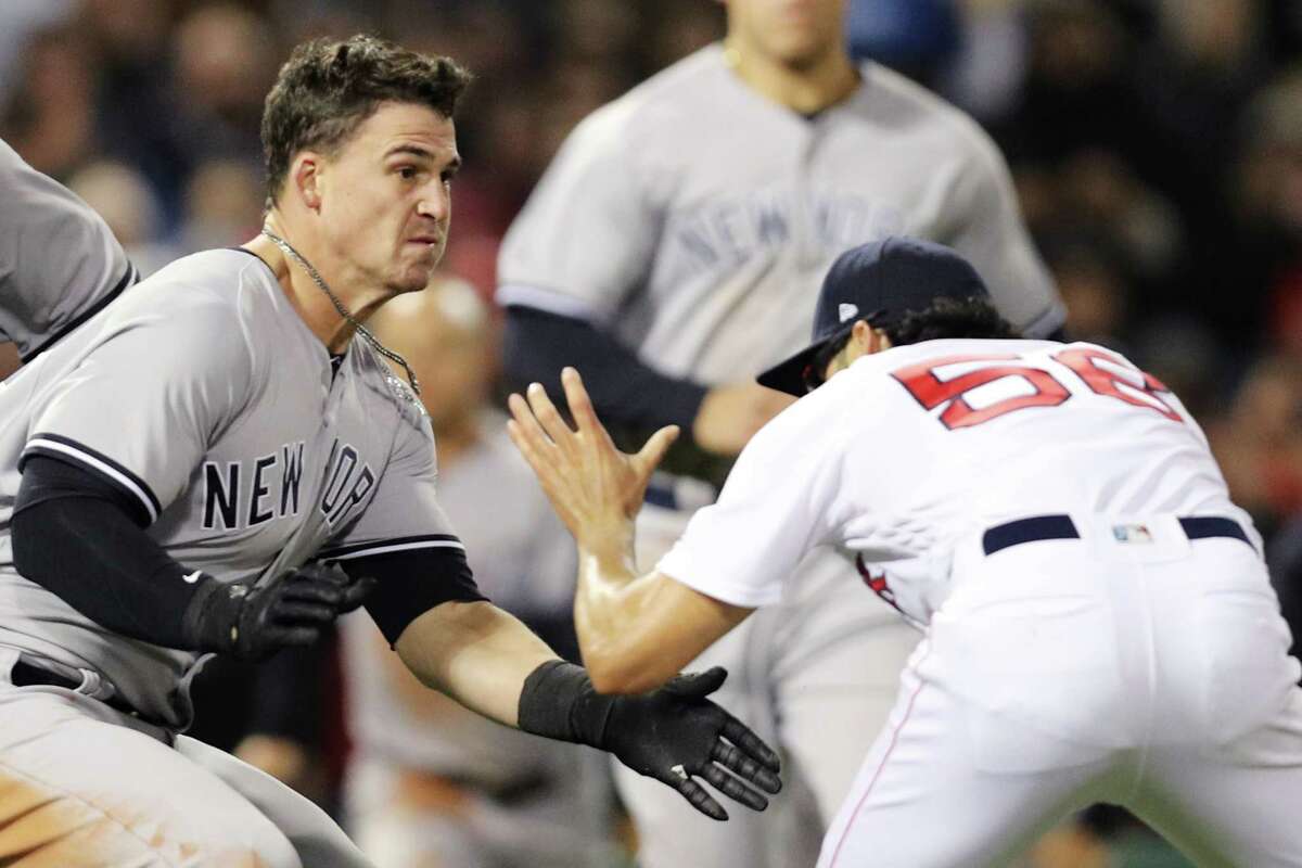 BOSTON, MA - APRIL 11: Tyler Austin #26 of the New York Yankees fights Joe Kelly #56 of the Boston Red Sox after being stuck by a pitch during the seventh inning at Fenway Park on April 11, 2018 in Boston, Massachusetts.