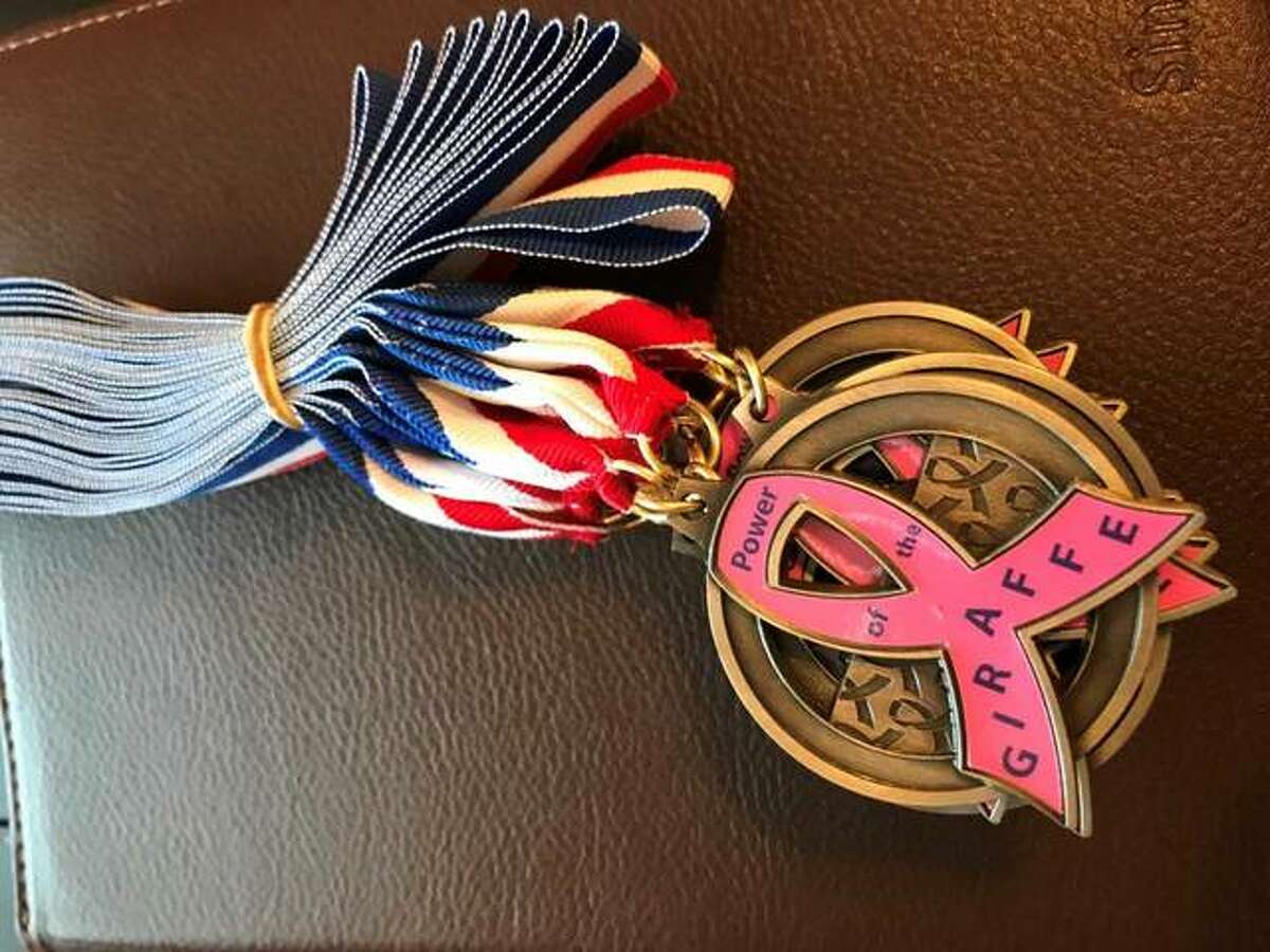 Medals to be given out are adorned with pink ribbons for breast cancer awareness.