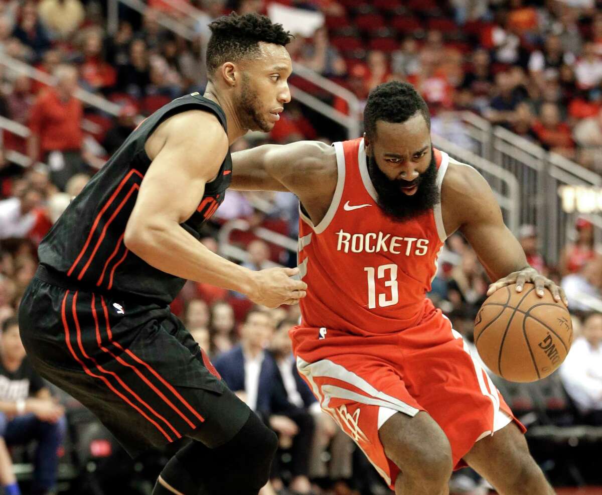 Houston Rockets guard James Harden (13) drives around Portland Trail Blazers forward Evan Turner, left, during the first half of an NBA basketball game Thursday, April 5, 2018, in Houston. (AP Photo/Michael Wyke)