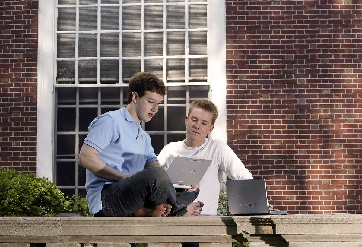 Mark Zuckerberg (L) and Chris Hughes (R), co-creators Facebook, photographed at Eliot House at Harvard University, Cambridge, MA. on May 14, 2004. Facebook was created in February 2004, 3 months prior to this photograph. 