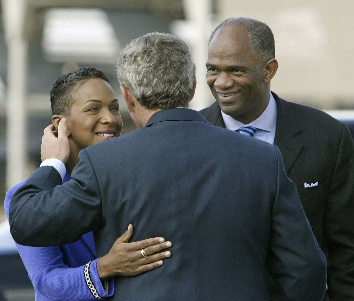 President Bush is welcomed to Houston after landing at Ellington Field by Pastor Kirbyjon Caldwell, right, and his wife Suzette at left, Friday, Sept. 12, 2003. President Bush will promote his faith-based initiative as he lends support to The Power Center, a huge multi-use complex celebrating ten years of community service in southwest Houston, run by Caldwell and business owners. (AP Photo/J. Scott Applewhite)