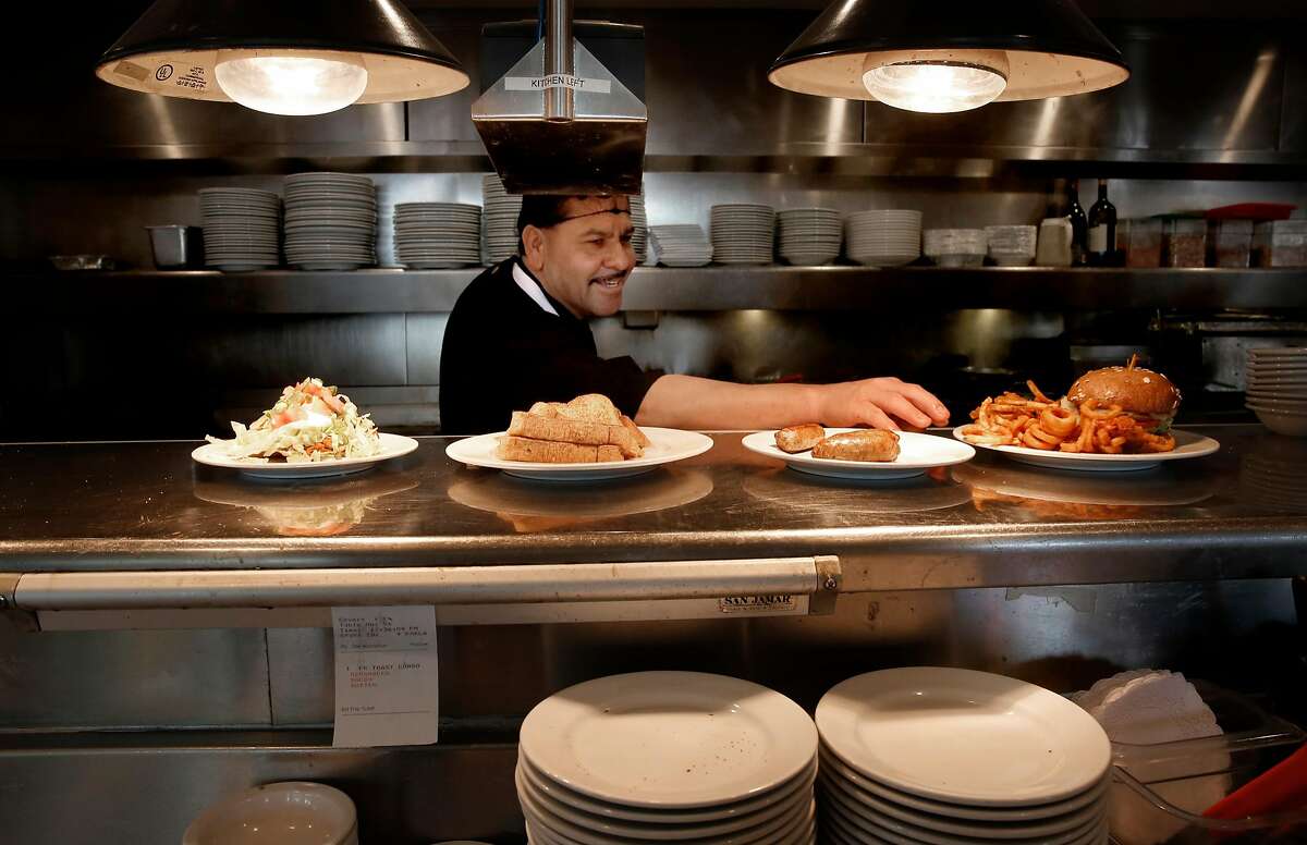 Line cook Barraza prepares lunchtime dishes the Buttercup Diner in downtown Oakland, Calif. on Wed. April 11, 2018. A new federal law about to go into effect would allow tips to be shared with cooks and dishwashers, could change the way the restaurant industry in California operates.