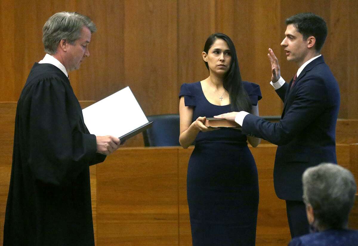 John F. Bash, right, is sworn in as U.S. attorney of the Western District of Texas by now-Supreme Court Justice Brett M. Kavanaugh. Bash’s wife, Zina Bash, looks on.