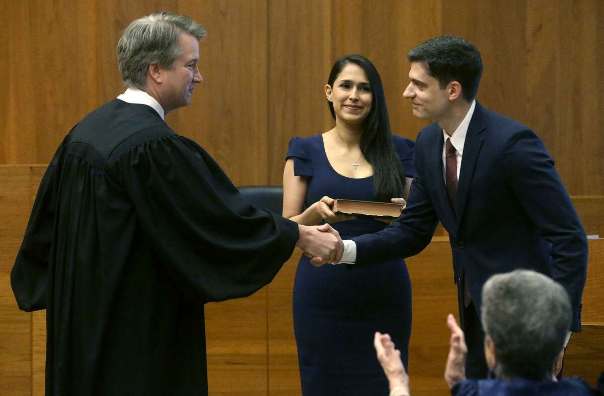 John Bash, right, selected Brett Kavanaugh, who was an appeals court judge at time, to swear him in as U.S. attorney for the Western District of Texas. Bash and his wife, Zina Bash, clerked for Kavanaugh.
