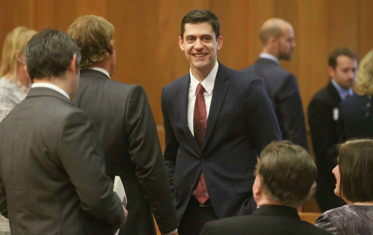 John Bash (center, facing) smiles before being sworn in April 2018 at the federal courthouse in Austin. Bash and a U.S. Attorney in Florida recently announced a $22.5 million settlement with a Belgium-based supplier of compounding medication over alleged fraud of its subsidiaries in the United States, exposed by whistleblowers in San Antonio and Florida.