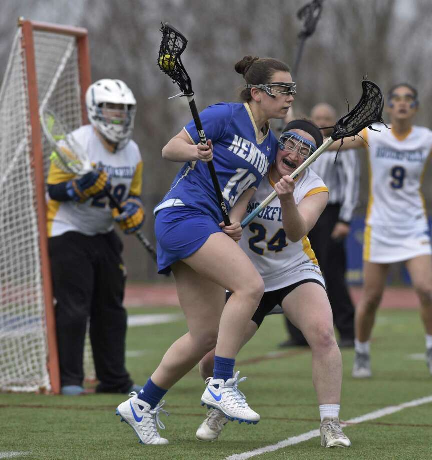 Newtown's Dylan Zahansky (19) and Brookfield's Sadie Smart (24) collide in front of the Brookfield goal in the girls lacrosse game between Newtown and Brookfield high schools, Thursday afternoon, April 12, 2018, at Brookfield High School, in Brookfield, Conn. Photo: H John Voorhees III / Hearst Connecticut Media / The News-Times