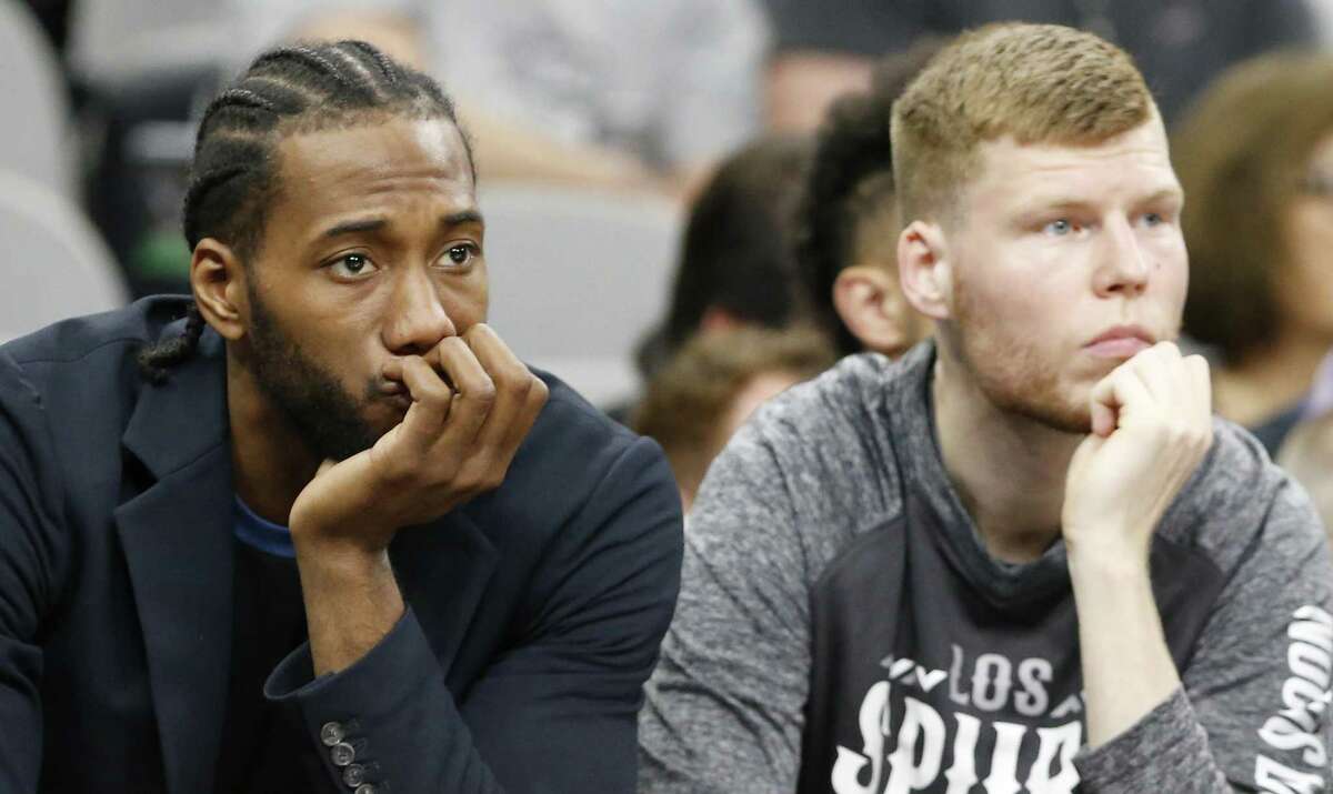 San Antonio Spurs forward Kawhi Leonard and center Davis Bertans watch first half action against the Memphis Grizzlies from the bench Monday March 5, 2018 at the AT&T Center.