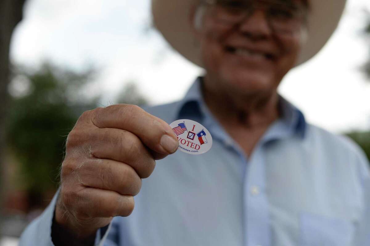 A Latino voter shows his “I Voted” sticker.