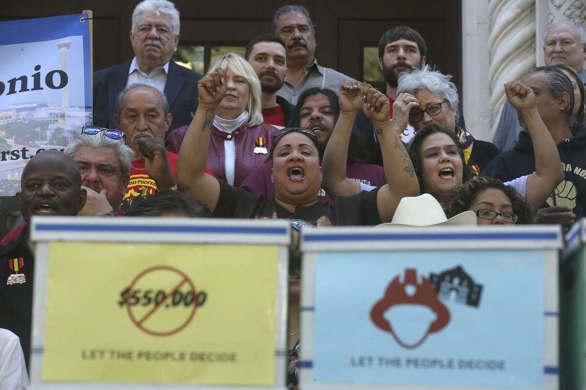 People cheer while Chris Steele, president of the San Antonio firefighters union, speaks Wednesday April 11, 2018 on the steps of City Hall about a petition campaign to call for a city charter amendment election in November. Steele and his supporters delivered thousands of signatures to the city clerk after he and his supporters voiced their opinions outside of city hall.