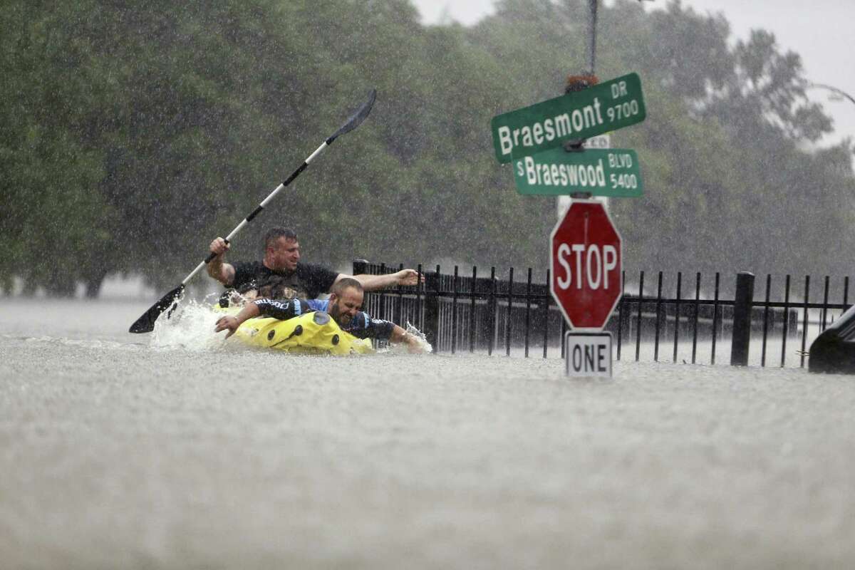 A pair of kayakers struggle against the current to make their way along what is normally South Braeswood Boulevard, adjacent to Brays Bayou. Hurricane Harvey brought unprecedented rain to southeast Texas, leading to thousands of high-water rescues as floodwaters rose in every direction.