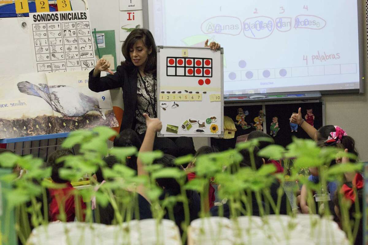 Rees Elementary School pre-kindergarten teacher Atenea Raptis helps her students with basic math skills at her classroom, Wednesday, April 4, 2018, in Houston. ( Marie D. De Jesus / Houston Chronicle )