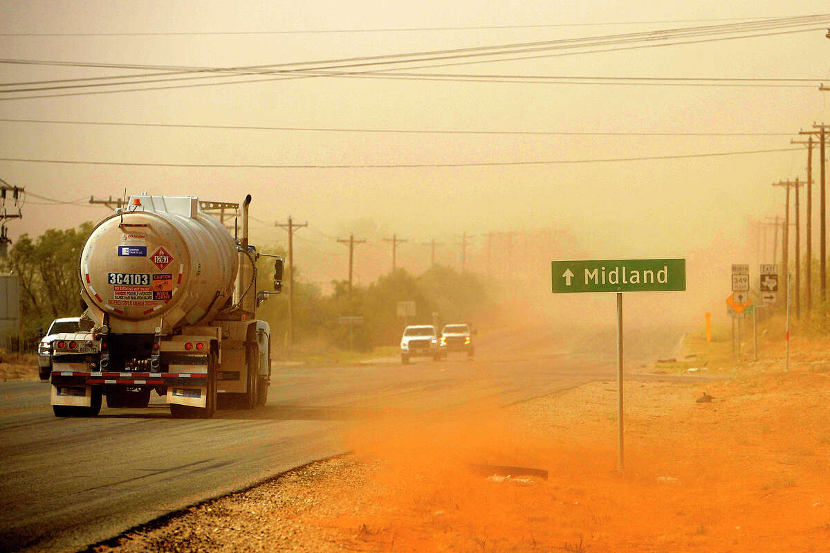 FILE PHOTO: A dust storm blows into Midland as oilfield traffic passes near the intersection of N State Highway 349 and County Road 160 south of Midland.