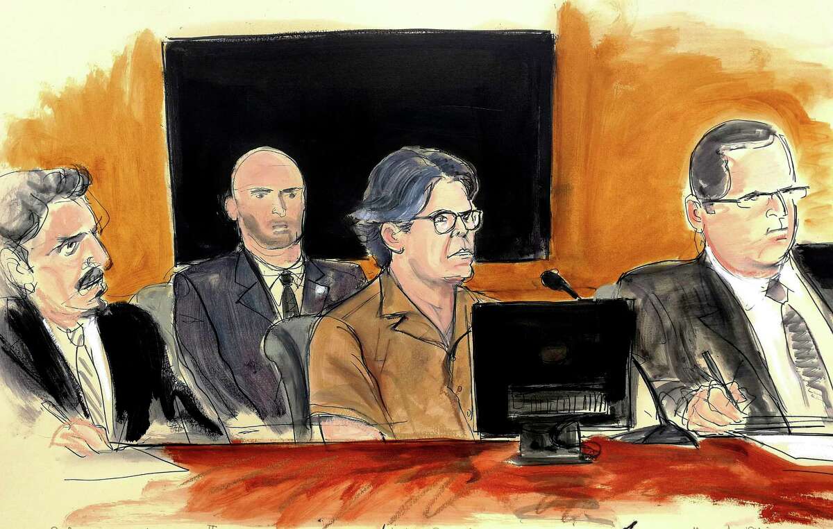 In this courtroom sketch, Keith Raniere, second from right, leader of the secretive group NXIVM, attends a court hearing Friday, April 13, 2018, in the Brooklyn borough of New York. In March, federal authorities raided a Halfmoon residence connected to the group and Raniere was later arrested in Mexico where the group also runs programs. Seated, from left, are defense attorney Paul DerOhannesian, a US marshal, Raniere and defense attorney Marc Agnifilo. (Elizabeth Williams via AP)