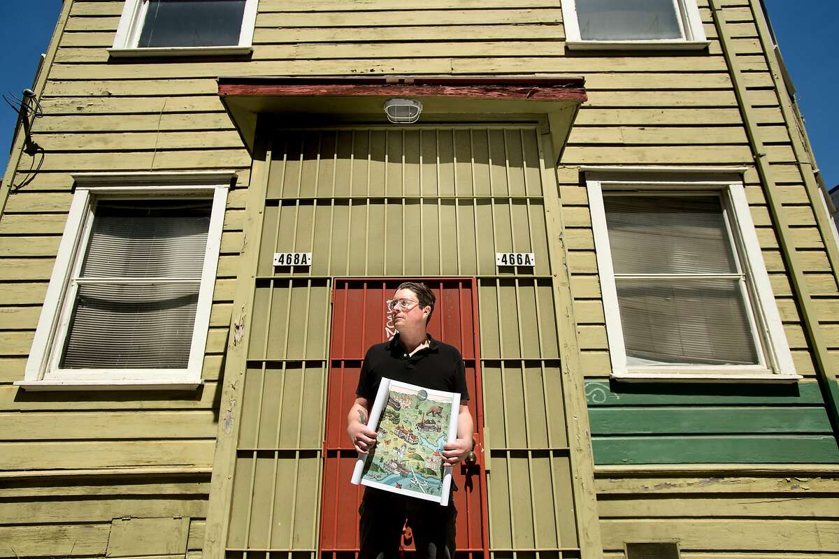 Liam O'Donoghue, who's Long Lost Oakland project recalls buildings, plants and wild animals from Oakland's past, stands with a map on Friday, April 13, 2018, in Oakland, Calif.