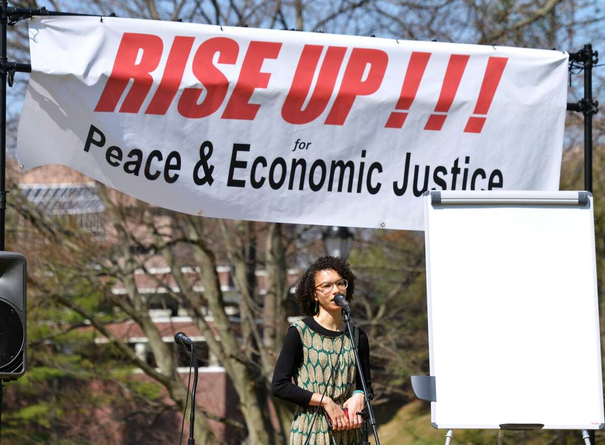 Event organizer Taylor Rae spoke during the Greenwich Rally for Peace & Economic Justice at the Greenwich Common on Saturday.