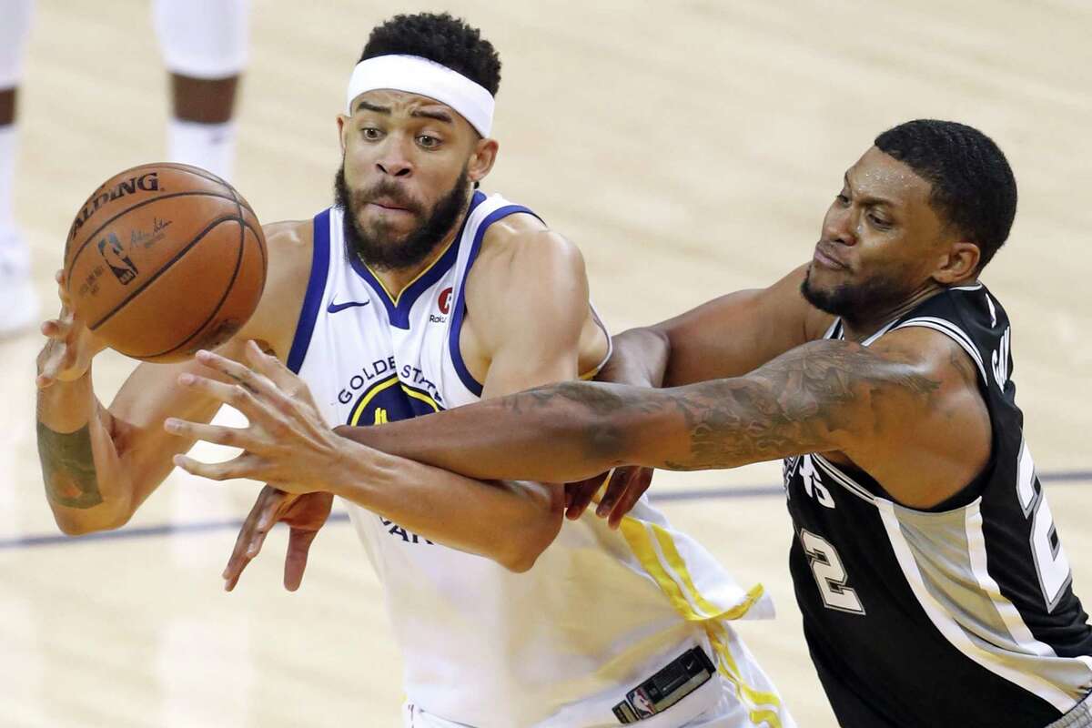 Golden State Warriors' JaVale McGee is fouled by San Antonio Spurs' Rudy gay in 3rd quarter during Warriors' 113-92 win in Game 1 of NBA Western Conference First Round playoff game at Oracle Arena in Oakland, Calif., on Saturday, April 14, 2018.