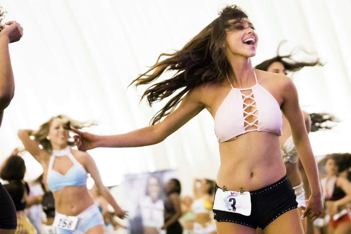 A candidate participating on the Houston Texans Cheerleader tryouts learns the routine the candidates will dance for the judges, Saturday, April 14, 2018, in Houston.