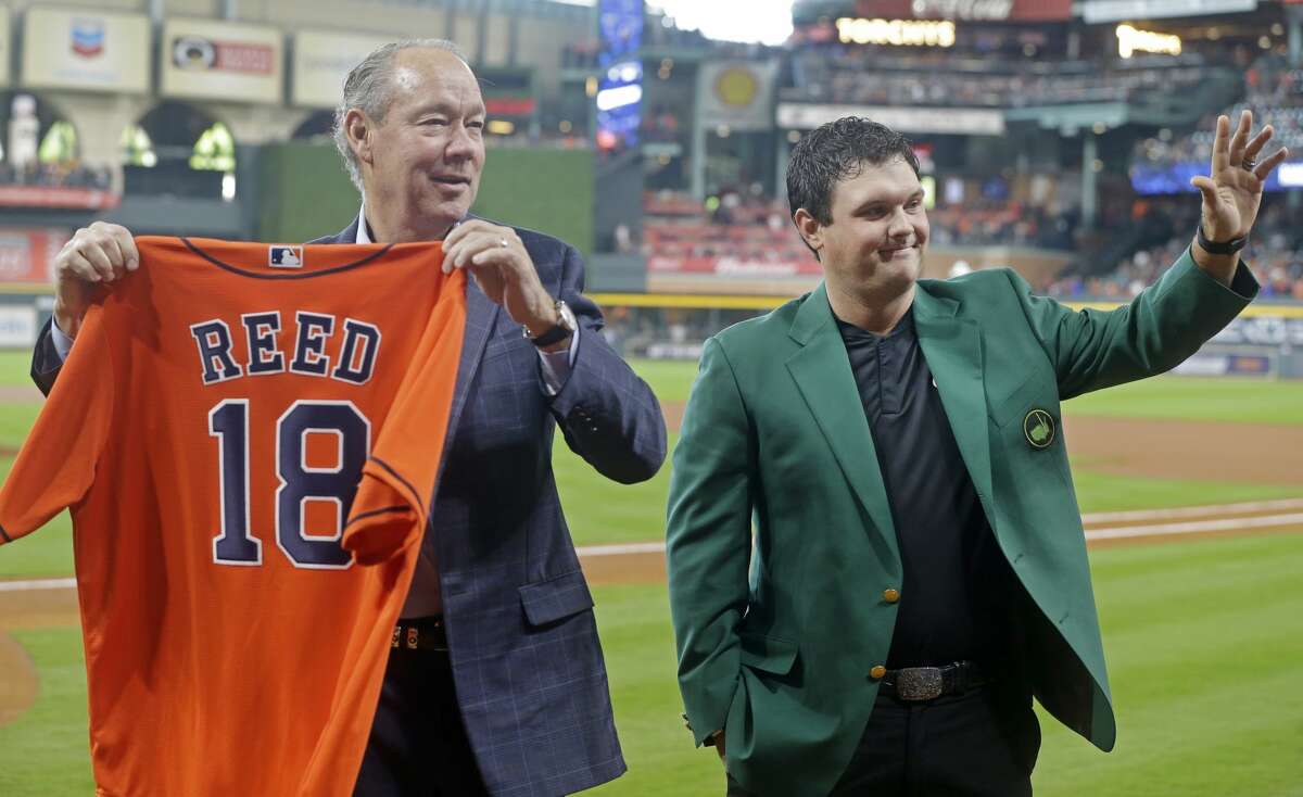 Houston Astros owner Jim Crane presents Masters winner, Patrick Reed, with a jersey during pre-game ceremonies at Minute Maid Park Saturday, April 14, 2018, in Houston. ( Melissa Phillip / Houston Chronicle )