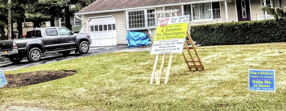 Signs urging residents to vote 'no' on the sewer referendum in Burnt Hills on Sunday.