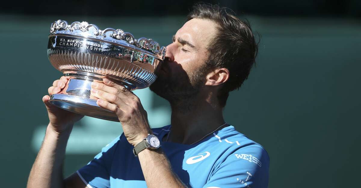 Steve Johnson poses with the U.S. Men's Clay Court Championship tennis trophy at River Oaks Country Club, Sunday, April 15, 2018, in Houston. (Yi-Chin Lee/Houston Chronicle via AP)
