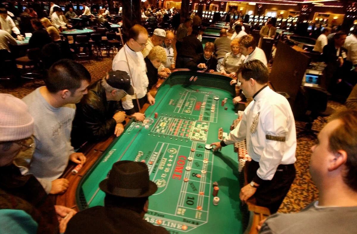 TIMES UNION STAFF PHOTO--MICHAEL P. FARRELL--Crowded craps tables at Turning Stone Casino in Verona , New York December 2002 .