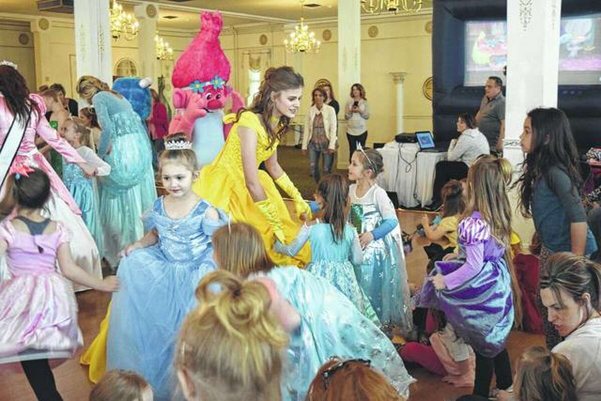 Kaylee Ford of Franklin, dressed as Belle from “Beauty and the Beast,” invites some of the crowd to dance at the Princess Party Sunday at Hamilton’s.