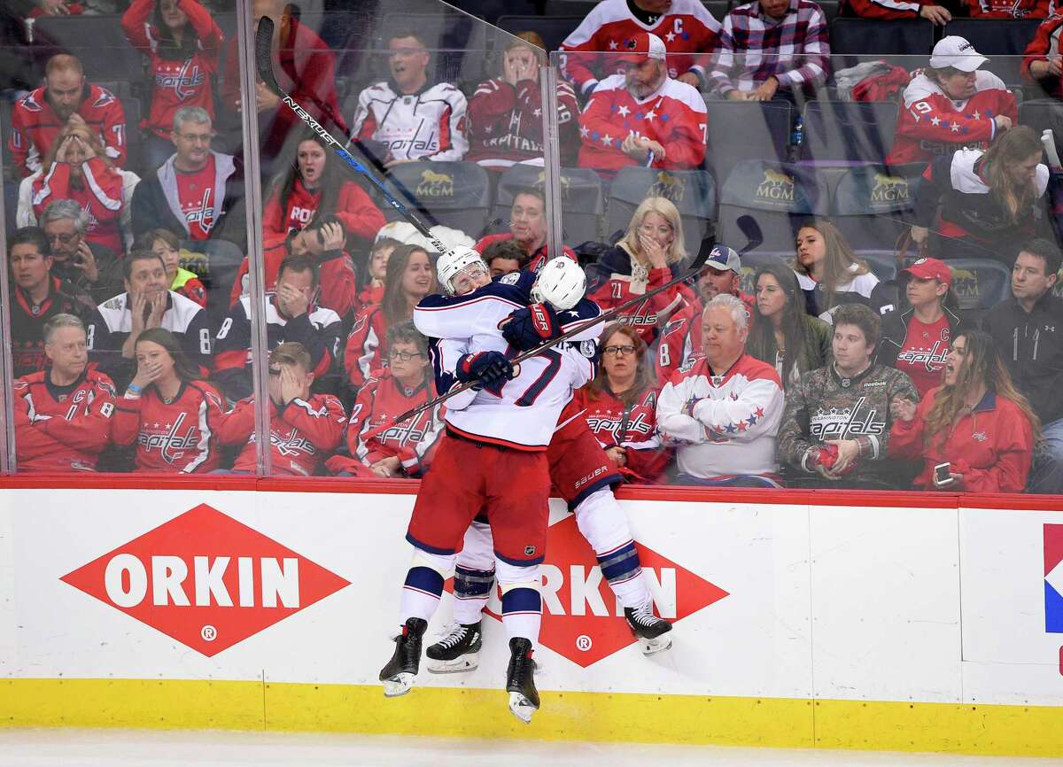 Columbus Blue Jackets left wing Matt Calvert (11) celebrates his game-winning goal with center Brandon Dubinsky (17) in overtime in Game 2 of an NHL first-round hockey playoff series against the Washington Capitals, Sunday, April 15, 2018, in Washington. The Blue Jackets won 4-3 in overtime. (AP Photo/Nick Wass)