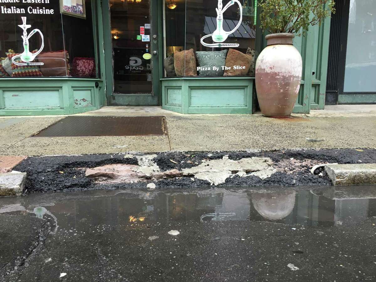 A broken curb on Orange Street in New Haven, reported to the city through the SeeClickFix app.