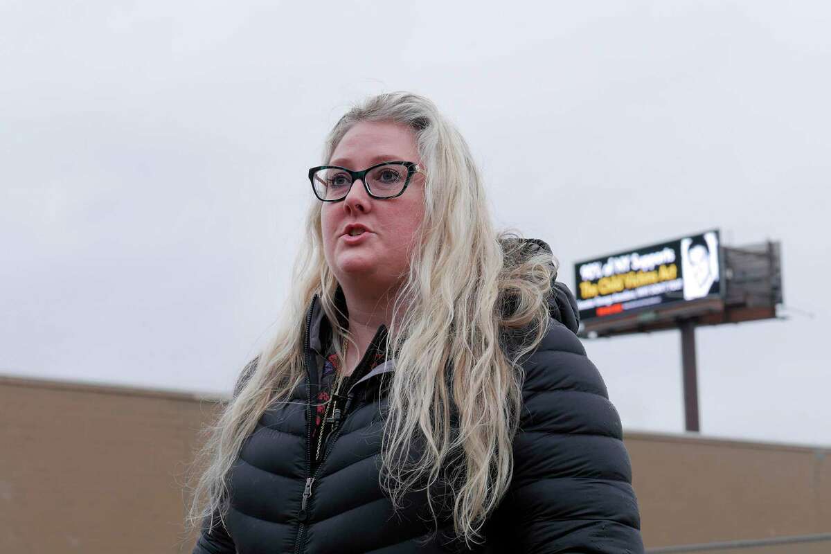 Kat Sullivan, a survivor of child sex abuse, holds a press conference near her new billboard calling out Senator George Amedore for not supporting the Child Victims Act, on Monday, April 16, 2018, in Albany, N.Y. The billboard, seen in the background, is located along Interstate 787. (Paul Buckowski/Times Union)