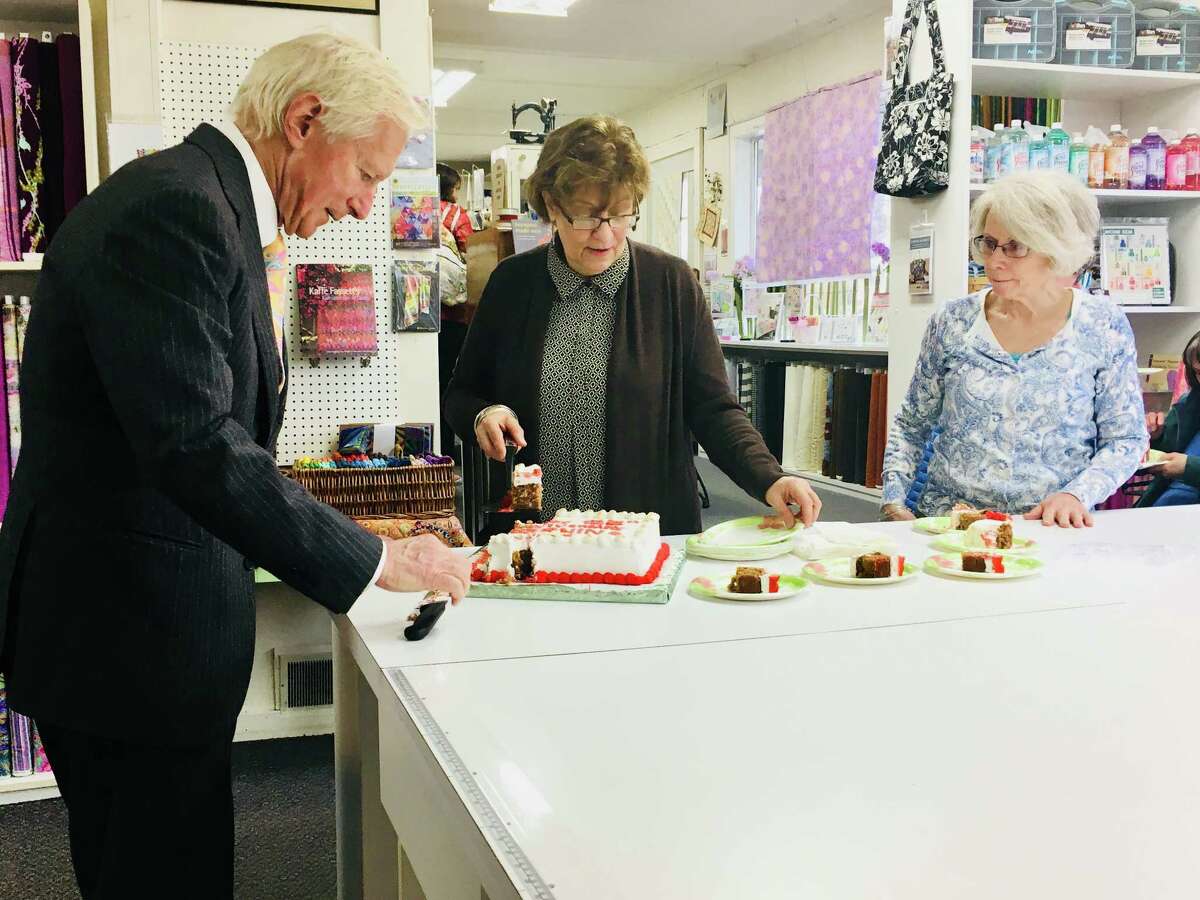 Hanspeter Ueltschi, chairman and owner of the Swiss sewing machine maker Bernina, cuts pieces of cake celebrating the company's 125th anniversary on Monday April 16, 2018 at the Gloversville Sewing Center. Ueltschi made the stop as part of a special anniversary celebration with the company's top dealers and its customers.