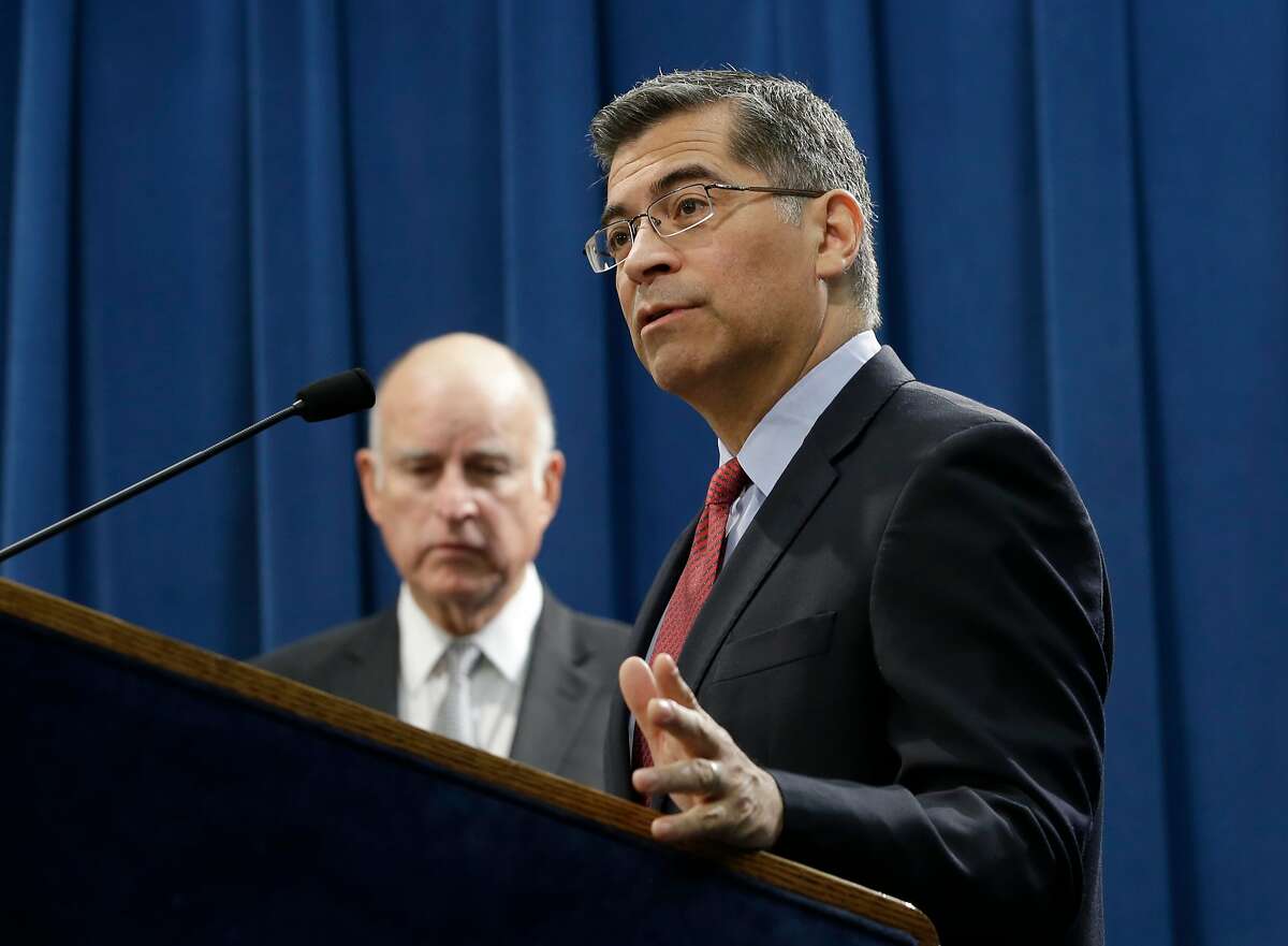 FILE - In this Wednesday, March 7, 2018 file photo, California Attorney General Xavier Becerra, right, accompanied by Gov. Jerry Brown, right, discusses remarks made by U.S. Attorney General Jeff Sessions, in Sacramento, Calif. Becerra, a Democrat, filed a federal lawsuit immediately after U.S. Commerce Secretary Wilbur Ross announced a citizenship question would be added to the 2020 census. The nation’s most populous state also has the highest number of foreign-born residents, most of whom are naturalized U.S. citizens or hold some other legal status. (AP Photo/Rich Pedroncelli)