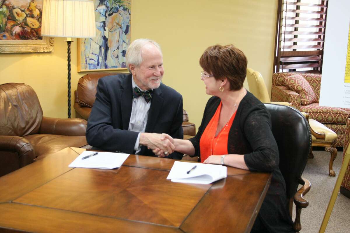 Midland College President Steve Thomas and UTPB President Sandra Woodley shake hands after signing an agreement to collaborate on an academic pathway for engineering students, allowing the transfer of credits between the two schools. Photo courtesy of Midland College