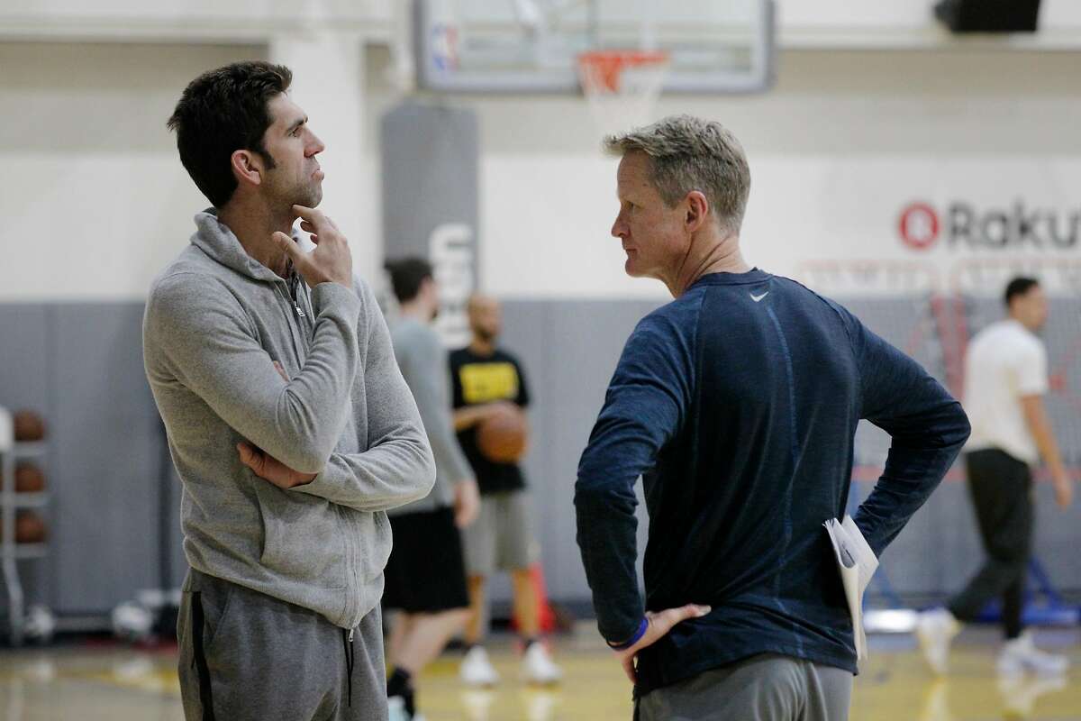 Bob Myers (l to r), general manager Golden State Warriors and Steve Kerr, head coach Golden State Warriors talk during practice at the Rakuten Performance Center on Monday, April 16, 2018, in Oakland, Calif.