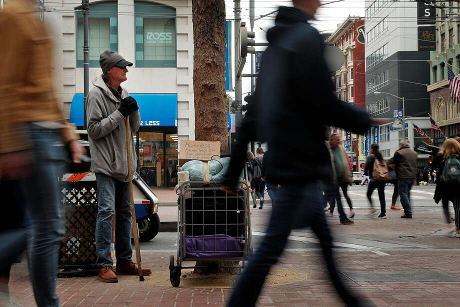 A man panhandles at the intersection of Market and Fourth Streets in San Francisco. It's not just hotel owners who are getting the brunt of tourists' complaints about how disgusting San Francisco's streets have become. It's also S.F. Travel, the city's visitor bureau. Photo: Carlos Avila Gonzalez / The Chronicle