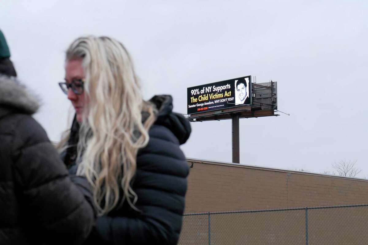 Kat Sullivan, a survivor of child sex abuse, gets set to start a press conference near her new billboard calling out Senator George Amedore for not supporting the Child Victims Act, on Monday, April 16, 2018, in Albany, N.Y. The billboard, seen in the background, is located along Interstate 787. (Paul Buckowski/Times Union)
