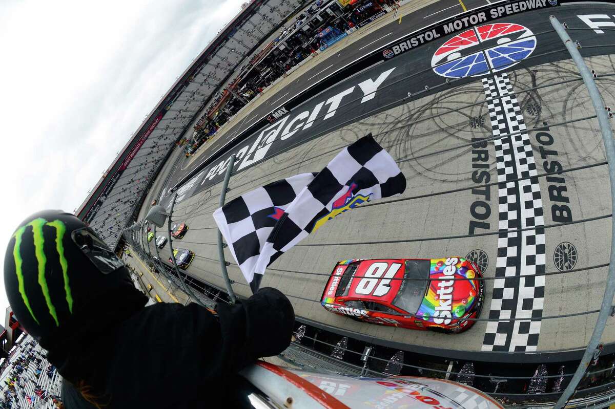 BRISTOL, TN - APRIL 16: Kyle Busch, driver of the #18 Skittles Toyota, takes the checkered flag to win the rain delayed Monster Energy NASCAR Cup Series Food City 500 at Bristol Motor Speedway on April 16, 2018 in Bristol, Tennessee. (Photo by Robert Laberge/Getty Images)