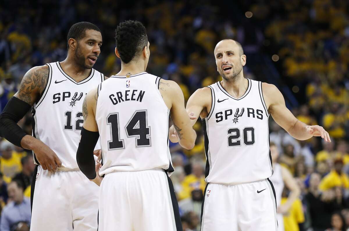 San Antonio Spurs' LaMarcus Aldridge, Danny Green, and Manu Ginobili talk during a break in the action in the third quarter during game 2 of round 1 of the Western Conference Finals at Oracle Arena on Monday, April 16, 2018 in Oakland, Calif.